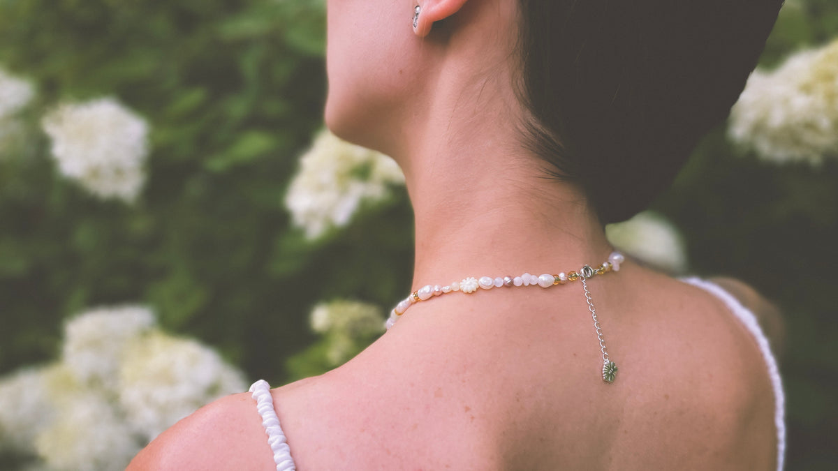 Semi-precious pearl necklace with pink accent and pale yellow flowers
