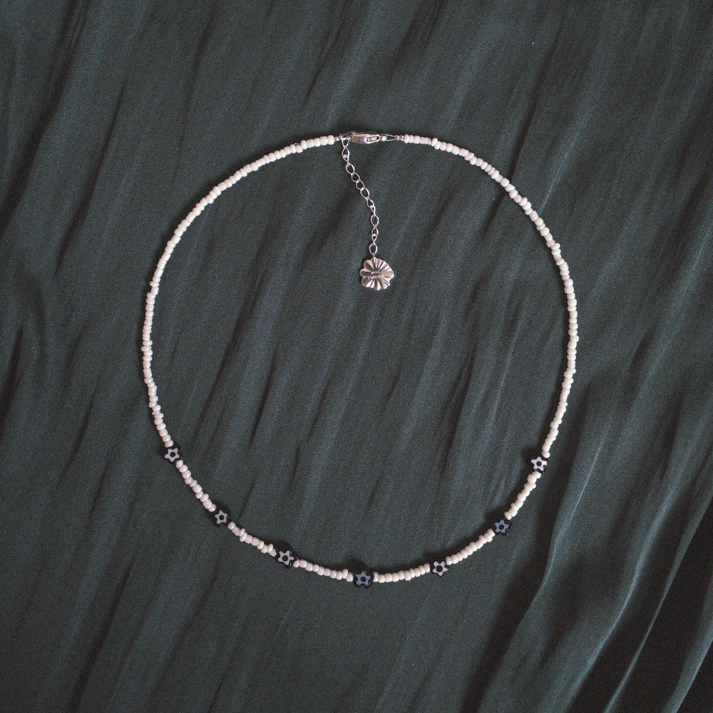 Necklace with small pearly beads and black millefiori glass flowers