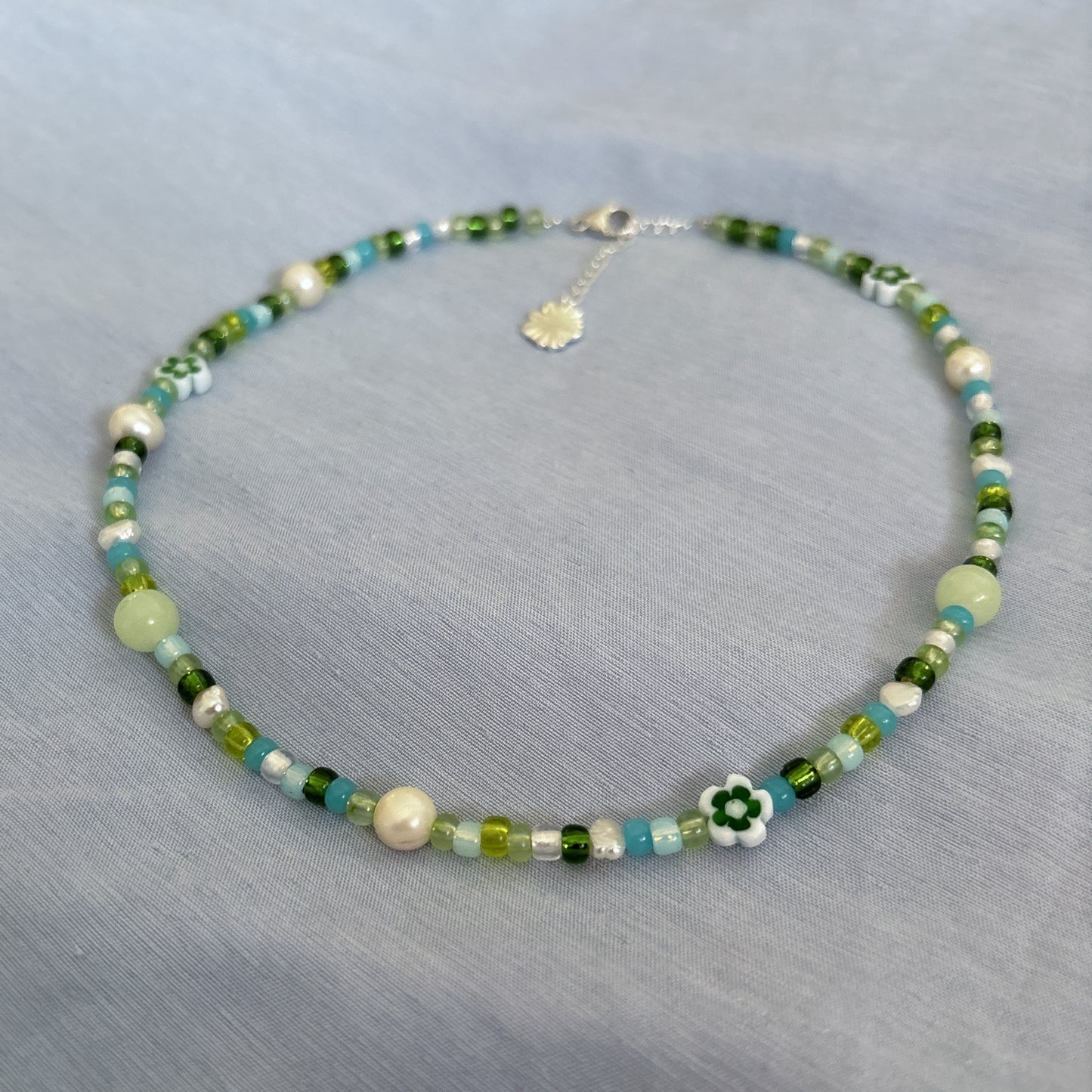 Semi-precious pearl necklace with pink accent and white flowers