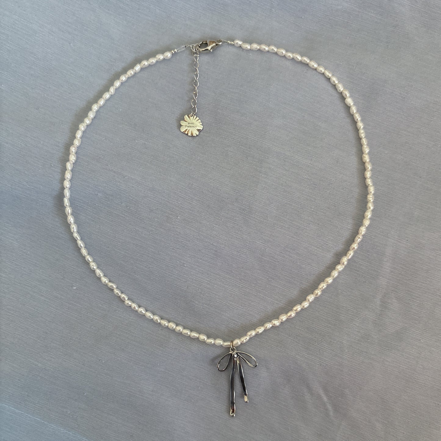 AAA grade small freshwater pearl necklace with rhodium silver knotted buckle