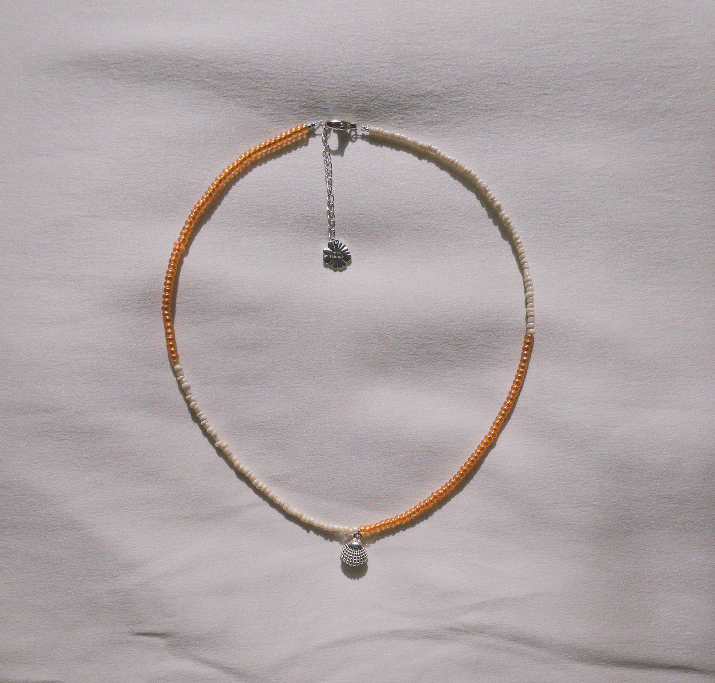 Orange and beige necklace with customizable pendants